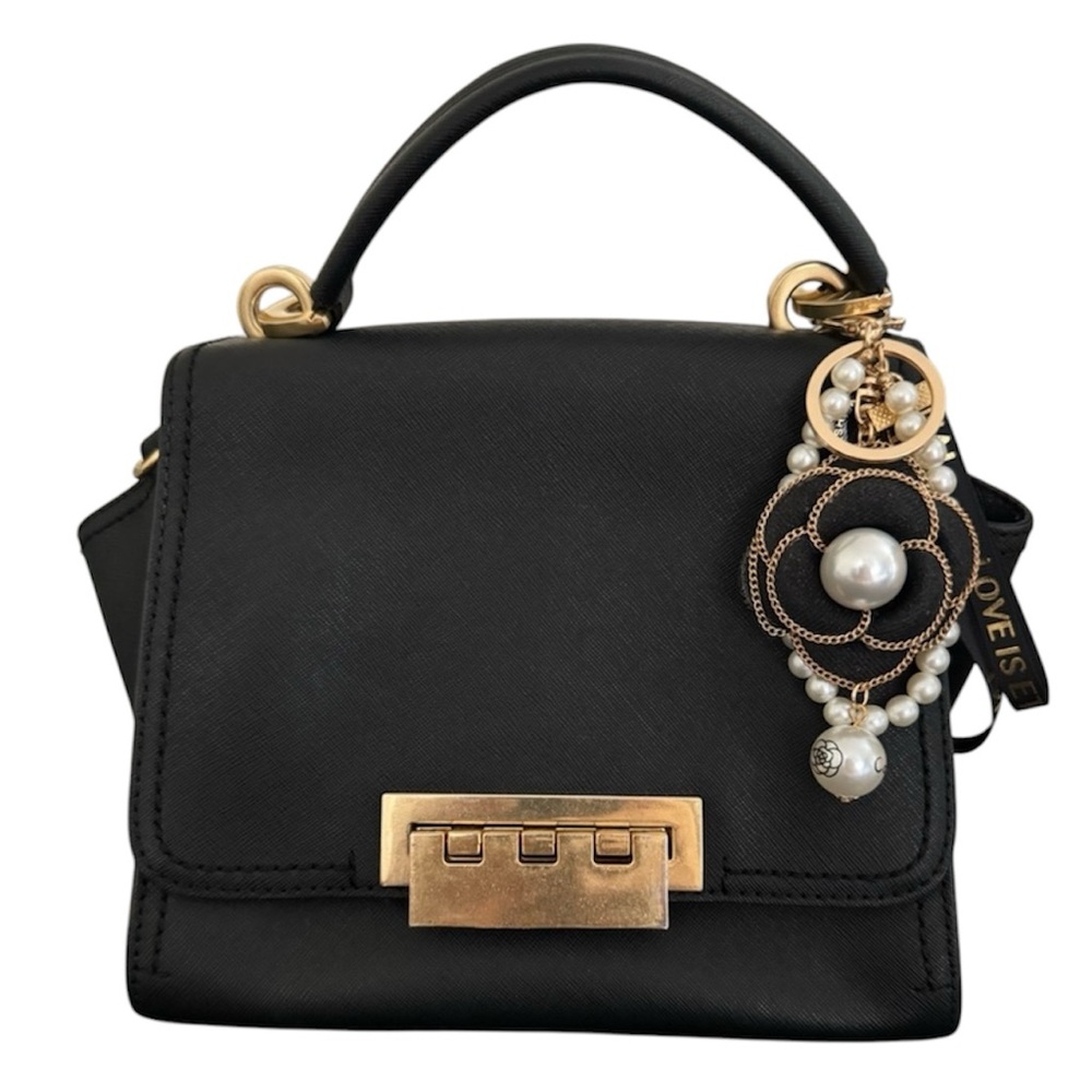 Zac Posen Eartha black leather satchel with gold hardware. Bag charm included.